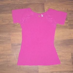 A pink shirt with flowers on the sides